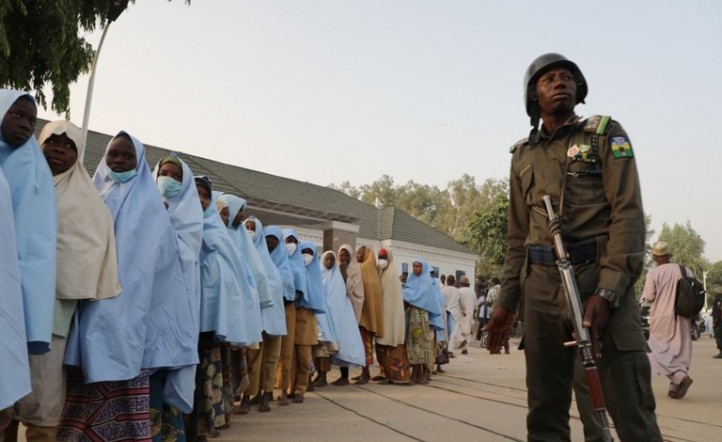Un soldado junto a un grupo de niñas previamente secuestradas en su internado en el norte de Nigeria (Foto de - / AFP)